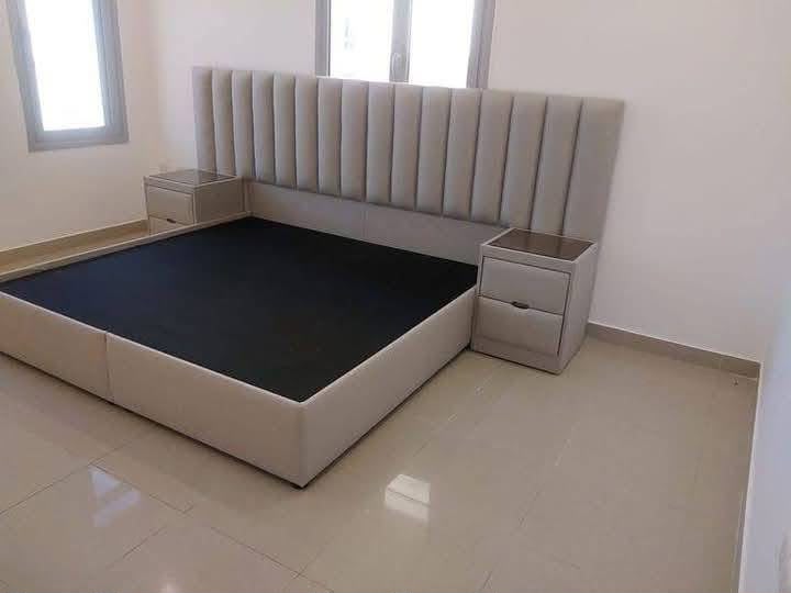 Neutral upholstered bed with matching bedside units